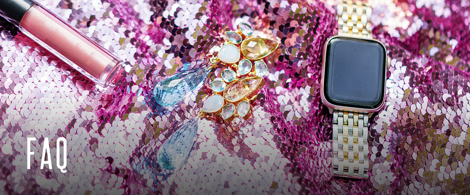 Pink lipgloss, jeweled earrings, and a gold Apple watch laying on a pink sequined background.
