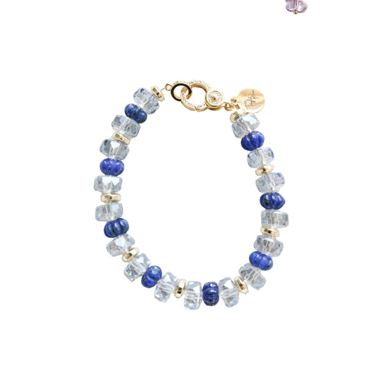 Beaded bracelet with blue and clear beads on a white background