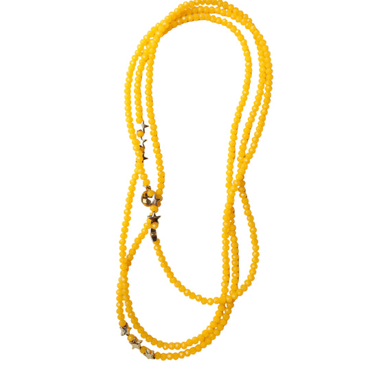 Yellow beaded necklace with star-shaped clasps on a white background