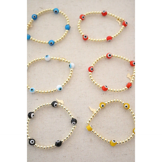 the evil eye goldie bracelet shown in blue, orange,white, red, yellow, and black color options