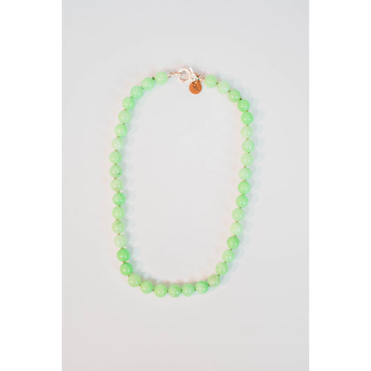 round light green beaded necklace with a gold pave lever clasp against a light background