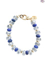 Beaded bracelet with blue and clear beads on a white background