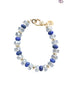 Beaded bracelet with blue and clear beads on a white background