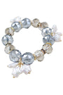 Beaded bracelet with gray, white, and gold beads on a white background