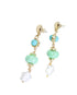 Pair of earrings with turquoise beads and gold accents on a white background