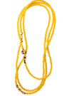 Yellow beaded necklace with star-shaped clasps on a white background