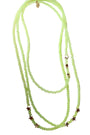 Green beaded necklace with star-shaped beads on a white background