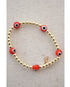 orange and white evil eye beads on a gold hematite stretch bracelet