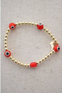 red and black evil eye beads on a gold hematite stretch bracelet