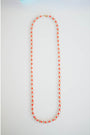 single strand crystal and coral long beaded necklace with gold-tone pavé clasp.