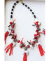 Red crystal beaded tassels are topped with ceramic wolf beads on a red and black beaded necklace with pave clasp. 