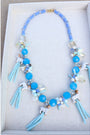 Tar Heel blue beaded tassels topped with ceramic ram mascot beads on a beaded blue necklace.