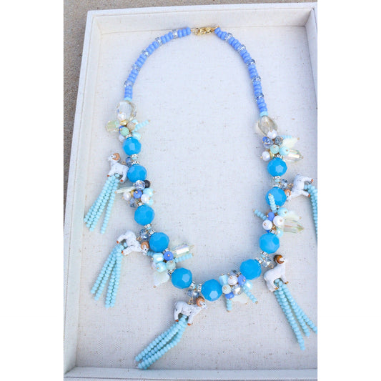 Tar Heel blue beaded tassels topped with ceramic ram mascot beads on a beaded blue necklace.