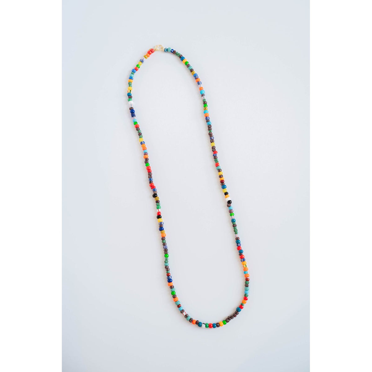 multicolor beaded necklace on a light grey background