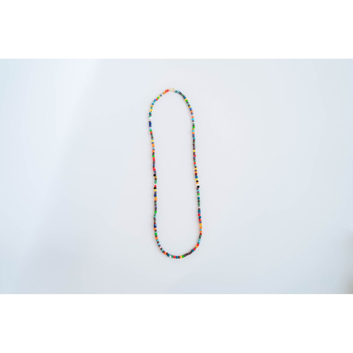 multicolor beaded necklace on a light grey background