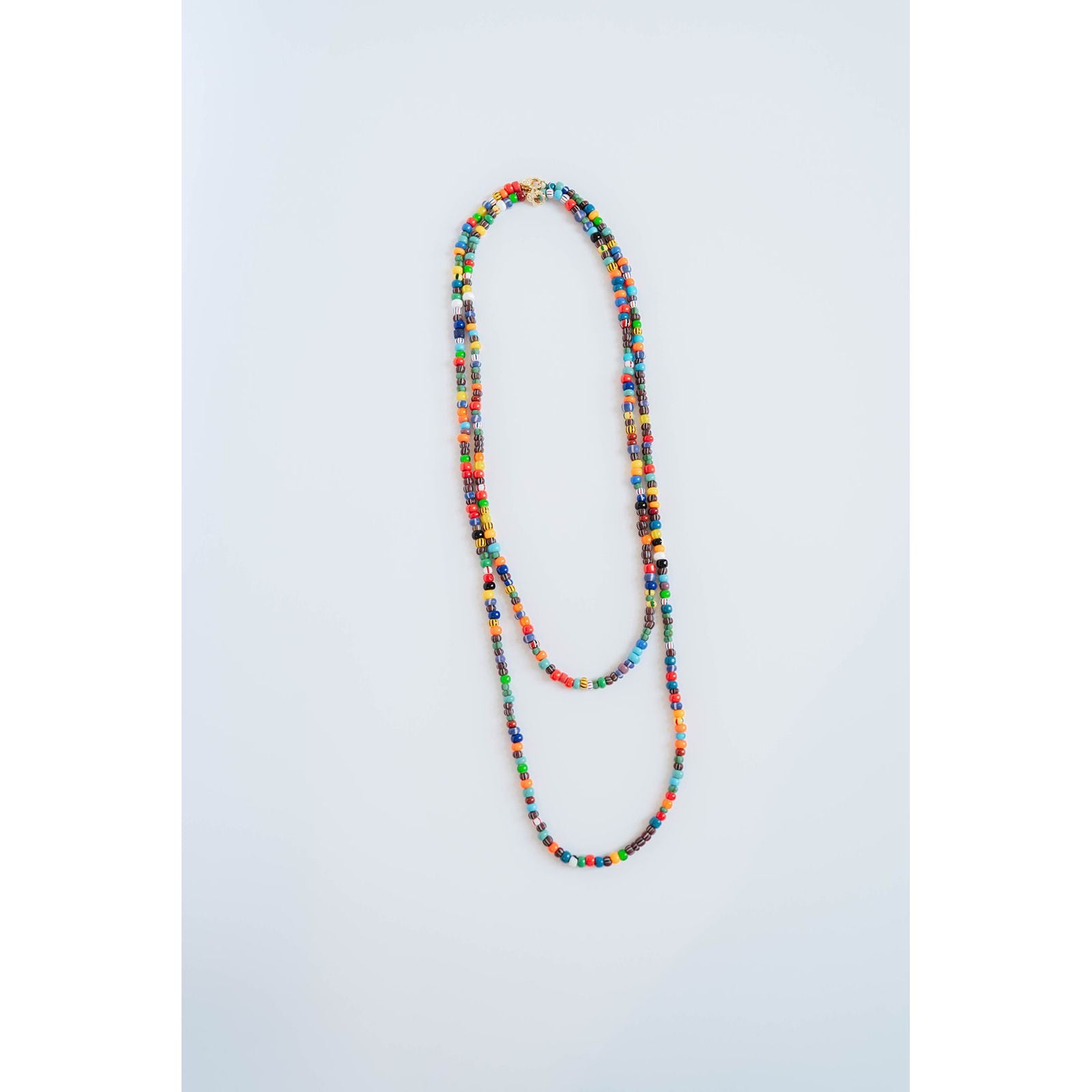layered multicolor beaded necklace on a light grey background