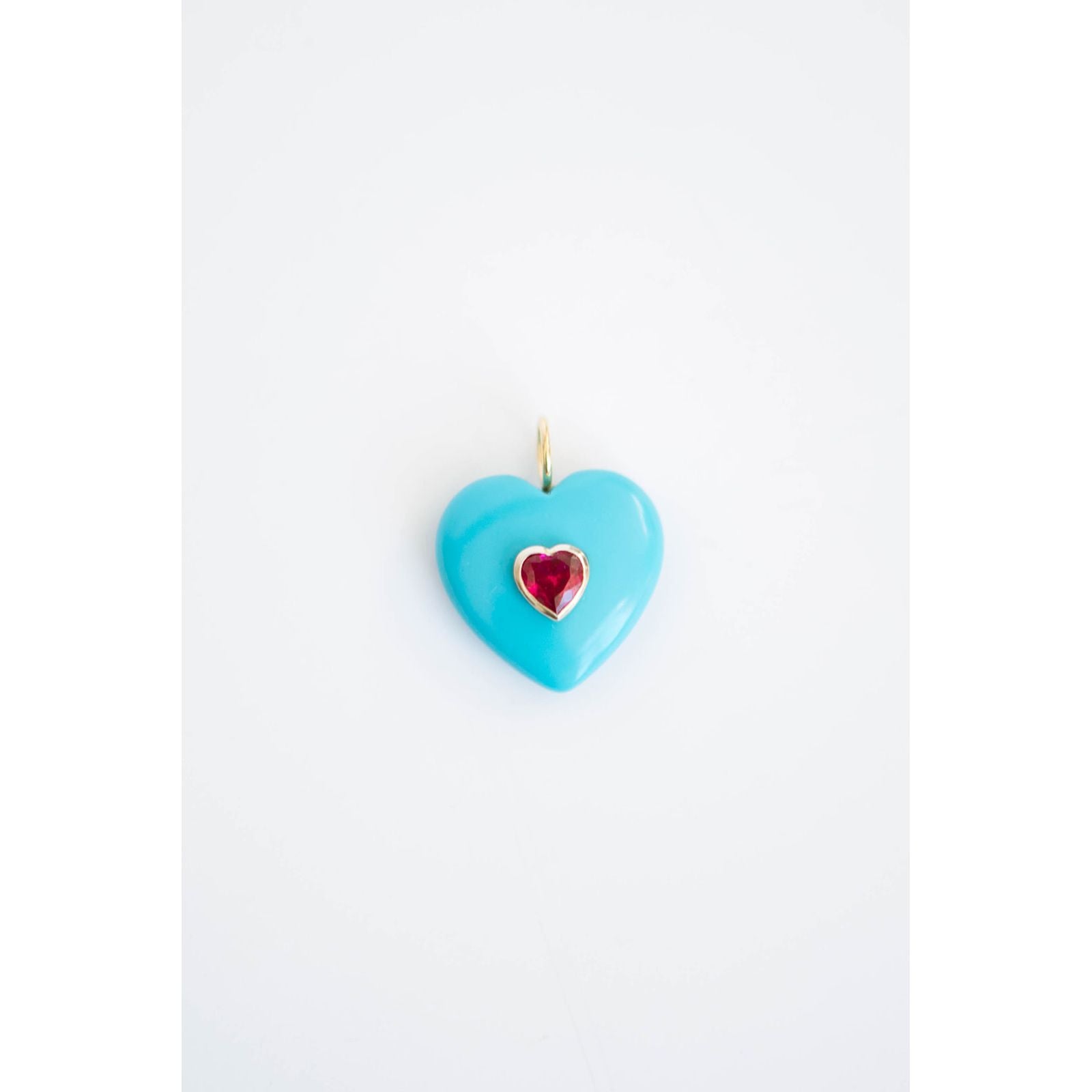 Turquoise heart-shaped pendant with a red crystal heart inset on a light background