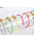 A collection of colorful enamel box chain bracelets with gold-tone clasp, displayed on a clear acrylic stand.