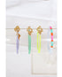 3 enamel chain bracelets in lavender, mint green, and yellow with gold pave lever clasps on a clear bracelet holder