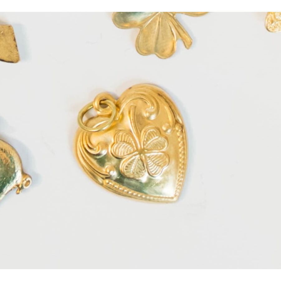 Vintage Gold heart-shaped pendant with clover design on a white background