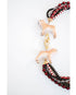 statement necklace with layered strands of red, black, and gold beads and two dog pendants with a gold pave clasp on a white background