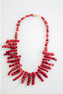 Red and black coral shaped beads collar necklace on a white background