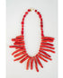 red coral collared necklace with coral-like charms draping the neck against a light background