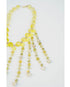 beaded necklace with yellow toned crystal bead accents on a light grey background