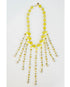 beaded necklace with yellow toned crystal bead accents on a light grey background