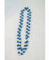 Long beaded necklace with crystal blue and turquoise and gold chain on a light gray background