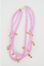 three-strand necklace with lavender crystal beads and multiple gold butterfly beads with a gold pave clasp