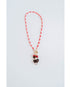 red and white color block cord necklace with a gold pave charm and an eagle pendant with black and red bead accents
