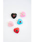 Colorful heart-shaped pendants with crystal accents on a white background