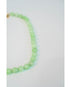 closeup shot of a light green beaded necklace against a light background