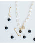 necklace with white star beads placed by gold hockey stick charms with pave detailing