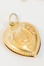 Double-sided gold/brass puffy heart charm with a horseshoe that reads "good luck"