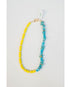 split necklace with neon yellow beads and turquoise howlite beads on a light background