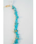 turquoise beaded necklace on a light grey necklace