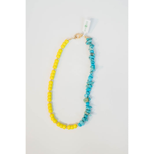 split necklace with neon yellow beads and turquoise howlite beads on a light background