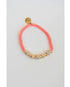 coral pink beaded bracelet with gold pave heart shaped beads on a light gray background