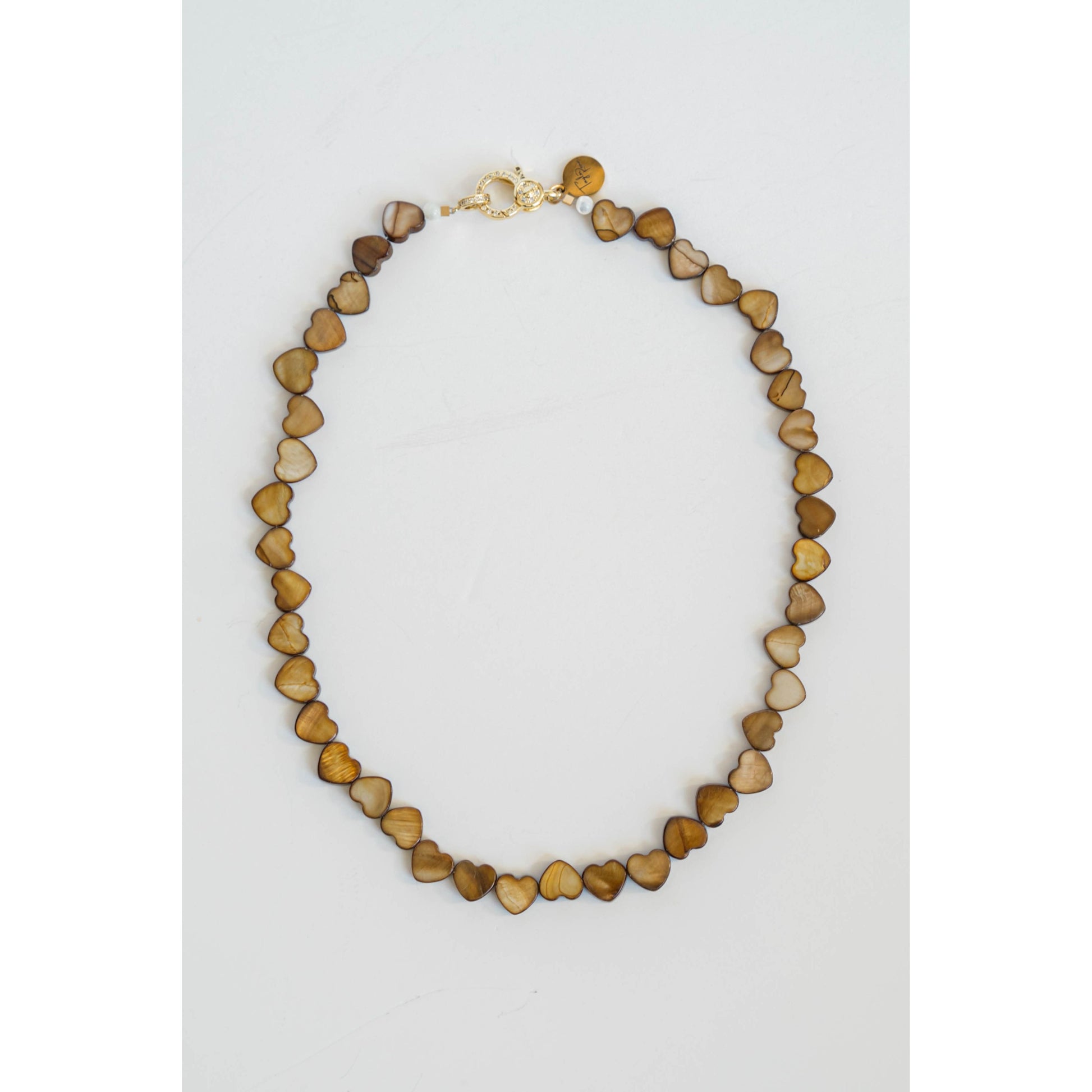 Necklace with heart-shaped beads on a light gray background