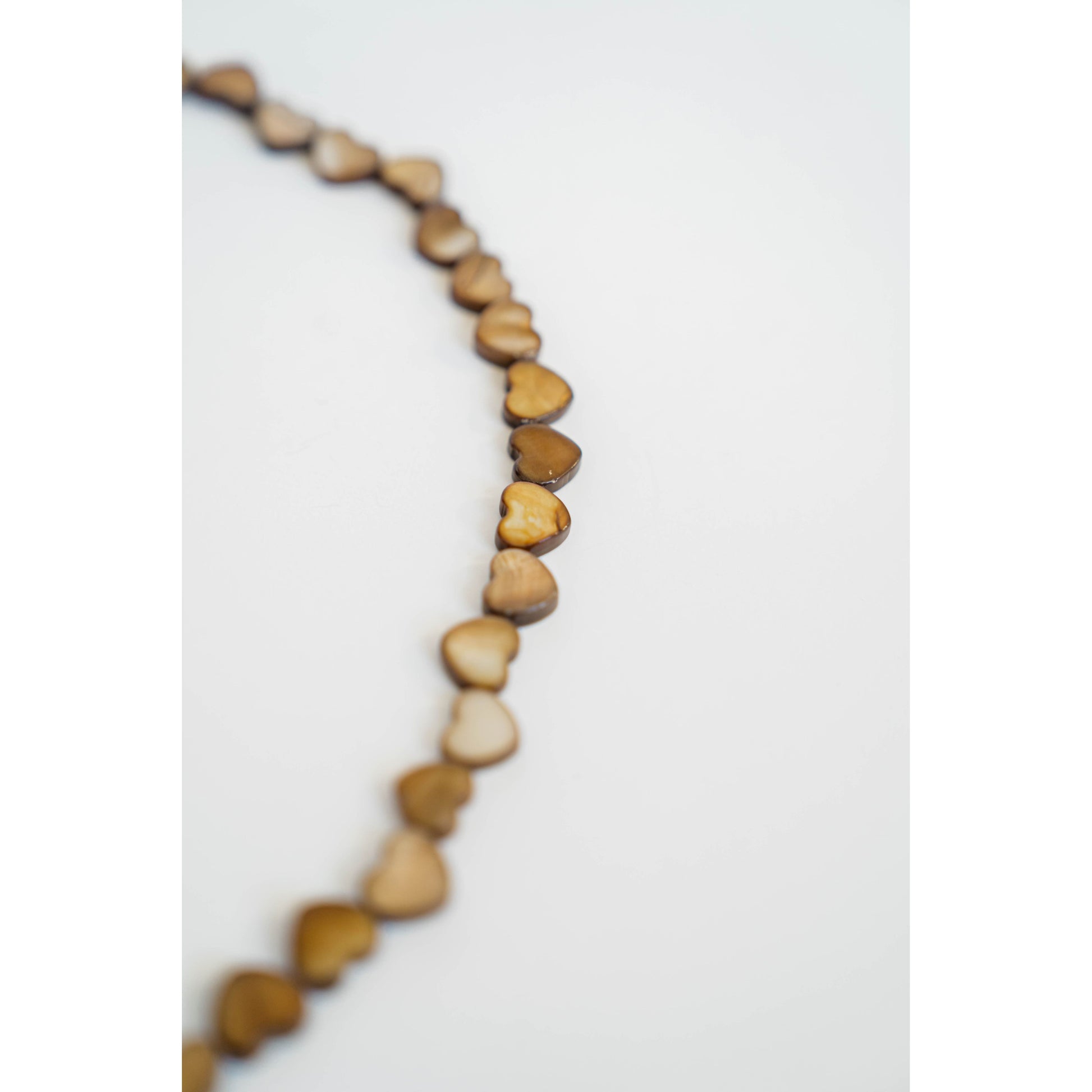 Necklace with heart-shaped beads on a white background