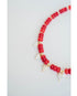 necklace with red beads, gold spacers, and white pearl heart charms on a light background