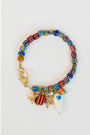 colorful beaded bracelet with charms of starfish and fish charm with a gold pave lever clasp on a light grey background