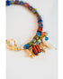 Colorful beaded bracelet with starfish and fish charms with a gold pave lever clasp on a white background
