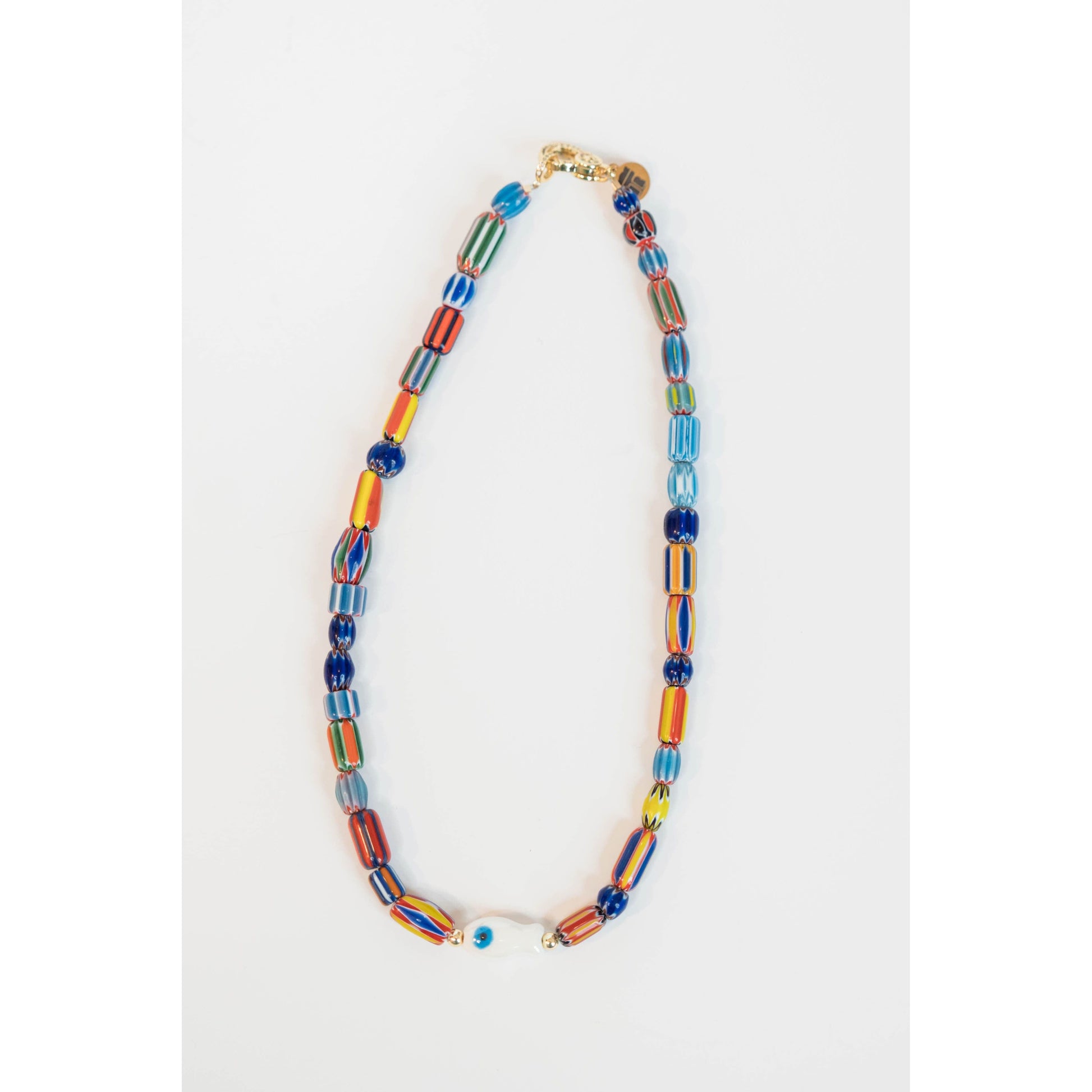 colorful painted stripe beaded necklace with a white fish charm on a light grey background