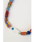 Colorful beaded necklace with a white fish pendant on a light gray background