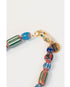 Closeup picture of a colorful striped beaded necklace with a gold clasp on a white background