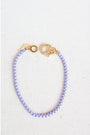 lavender box chain bracelet with a gold pave lever clasp on a light grey background