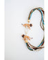 statement necklace with multiple strands of multicolored beads  and lion figurines with a gold pave clasp on a white background